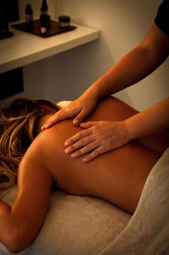 a woman sitting on the floor with her hands on her stomach at Hôtel & Spa Version Maquis Citadelle in Bonifacio