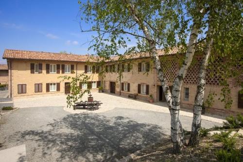 a large building with a tree in front of it at Ca'Rapulin in Calosso