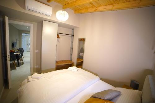 a bedroom with a bed and a dining room at Center Oasis Appartmens in Tirana