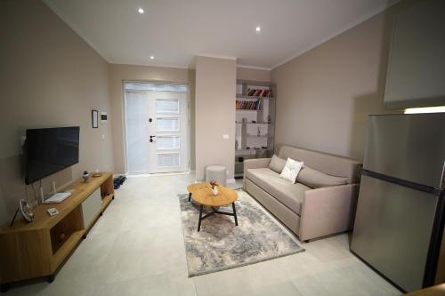 a living room with a couch and a table at Center Oasis Appartmens in Tirana