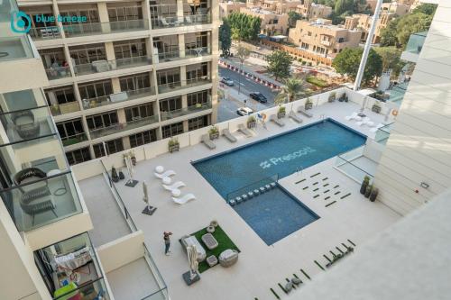 an overhead view of a swimming pool on a building at Blue Breeze - Trendy Studio with Balcony & Stylish Interiors in Dubai