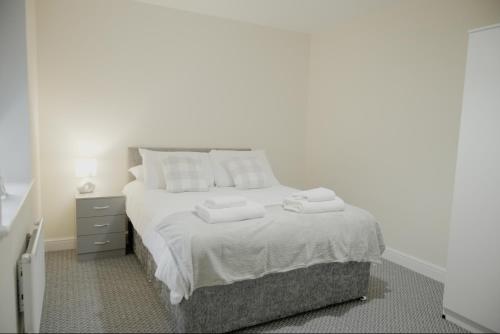 a bedroom with a bed with towels on it at Katrina Suite in Boston