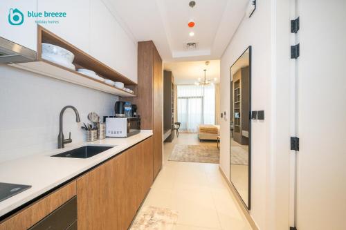 a kitchen with a sink and a counter at Blue Breeze - Trendy Studio with Balcony & Stylish Interiors in Dubai