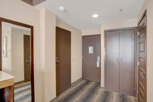 an empty hallway with two doors and a room with wooden floors at Crowne Plaza Hotel Harrisburg-Hershey by IHG in Harrisburg