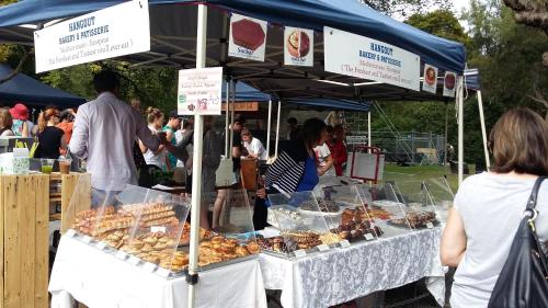 people standing around a food stand at a farmers market at Jan's Boutique B & B Suite in Christchurch