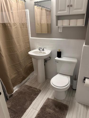 a bathroom with a toilet and a sink at Warm and Welcoming in Los Angeles