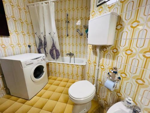 a bathroom with a toilet and a washing machine at Suite Euforbia Bilo - Sanremo in Sanremo
