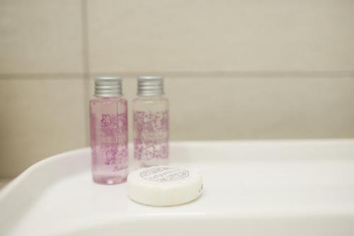 two bottles are sitting on top of a sink at Ca'Rapulin in Calosso