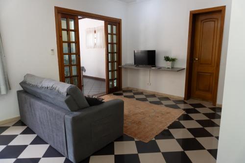 a living room with a couch and a checkered floor at Mansão Adalgisa in Osasco