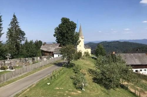 a church on a hill next to a road at Katharina Haus, Wiel in Wiel