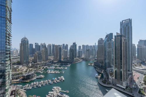 a view of a river in a city with tall buildings at Free housekeeping visits during your stay - StayShort - Marina Views and a 3 Bedroom Apartment in Dubai Marina in Dubai