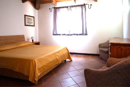 En eller flere senge i et værelse på Villa Corallina