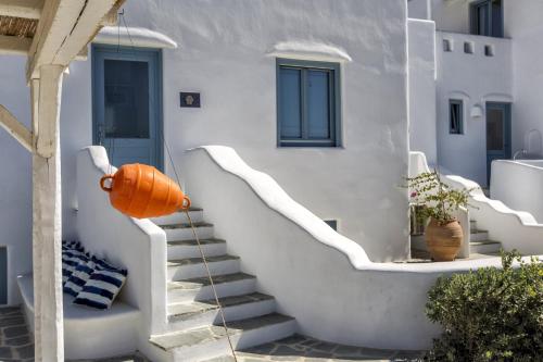 an orange pumpkin on the stairs of a house at Casa Perla in Mikri Vigla