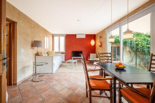 une cuisine et une salle à manger avec une table et des chaises dans l'établissement Val de Menton, Charmant 3 pièces atypique, jardin et terrasse à 7 minutes à pied du centre ville, à Menton