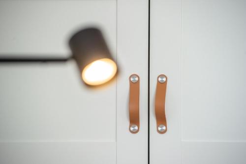 a close up of a door with a light on it at Apartament Korfantego 9 in Gliwice