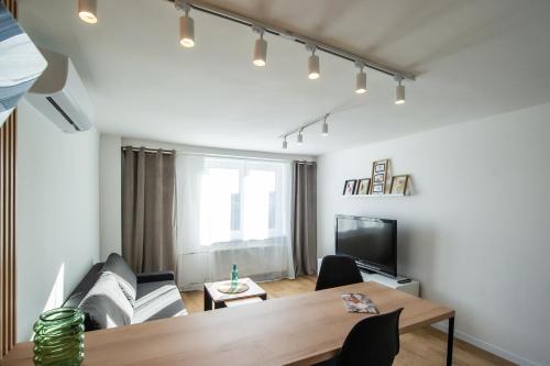 a living room with a couch and a table at Apartament Korfantego 9 in Gliwice