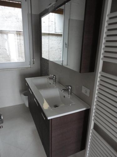 a bathroom with a sink and a mirror at Ferienwohnung Maderno in Affoltern