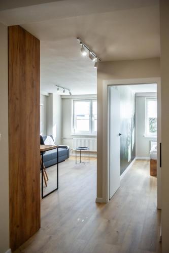 an open living room with a table and a couch at Apartament Korfantego 9 in Gliwice