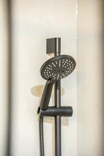 a hair dryer on a stand in front of a door at Apartament Korfantego 9 in Gliwice