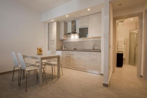 a kitchen with a table and chairs in a room at Excelsior in Piombino
