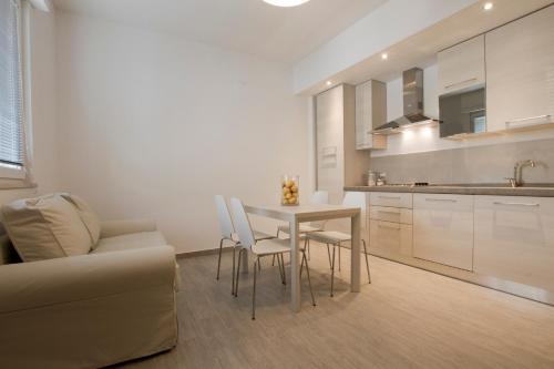 a kitchen with a table and chairs and a couch at Excelsior in Piombino