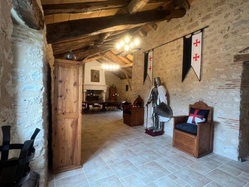 a living room with a chair and a table at Le Relais des Chevaliers "La Chambre des Templiers" in Cordes-sur-Ciel