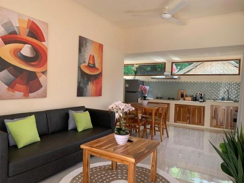 a living room with a couch and a table at Central house with 2 large bedrooms in Kuta Lombok
