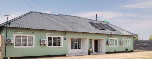 a green house with solar panels on the roof at Wamz Apartments And Tours A in Sankaia