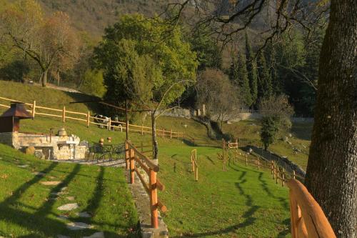 a park with a fence and a field with trees at Chalet Ca' la Fratela in Malcesine