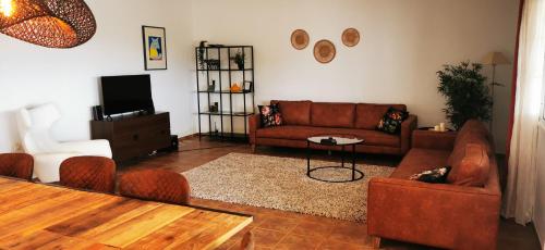 a living room with a couch and chairs and a table at Villa Gozo Holiday house in Teguitar