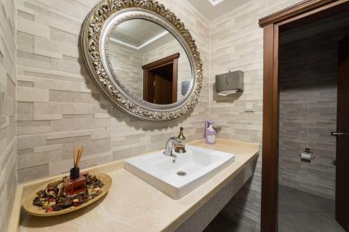a bathroom with a sink and a mirror at Felicity Hotel İstanbul in Istanbul