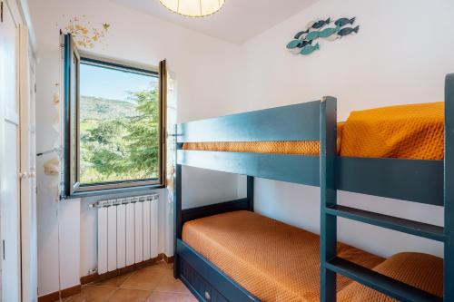 a bunk room with bunk beds and a window at villa olimpia in Nerano
