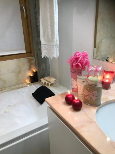 a bathroom with a sink and two apples on a counter at Quinta de Santa Marinha in Castedo