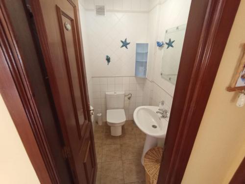 a bathroom with a toilet and a sink at Playa de Mogn Alysio 8 in Puerto de Mogán