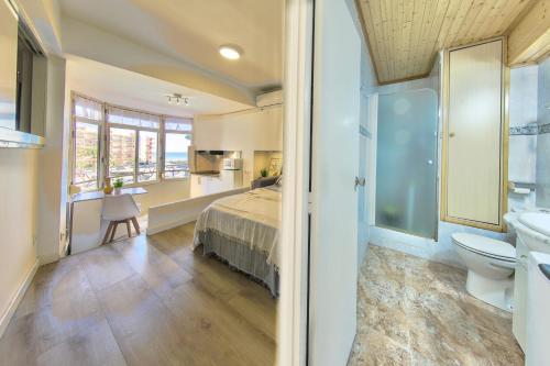 a bedroom with a bed and a bathroom with a sink at Mediterranean Way - Promar 248 in La Pineda
