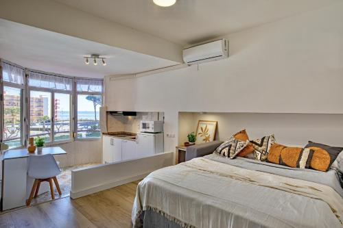 a bedroom with a large bed and a kitchen at Mediterranean Way - Promar 248 in La Pineda