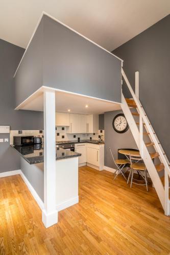 a kitchen and dining room with a staircase in a house at 1 Bed Old Town City Studio near Theatre Suit Work or Leisure in Hull