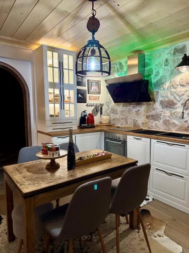 a kitchen with a wooden table and chairs at villa in Parnassos in Arachova