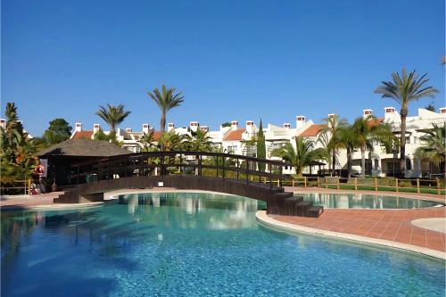 a bridge over a swimming pool at a resort at Luxury 3 Bedroom Apartment on Gated Complex in Quarteira