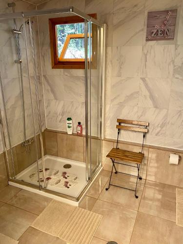 a shower with a bench in a bathroom at Wild Glamping Portugal com jacuzzi privado Serra de Arga, Viana do Castelo in Viana do Castelo