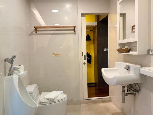 a bathroom with a toilet and a sink at The Height Khaoyai Resort in Ban Huai Sok Noi