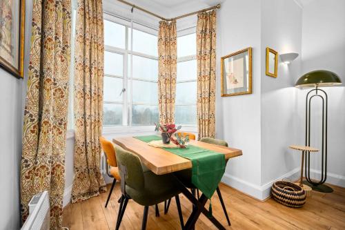 a dining room with a table and chairs and a window at Stylish Two-Bedroom Apartment with Balcony & Parking 9NC in Birmingham