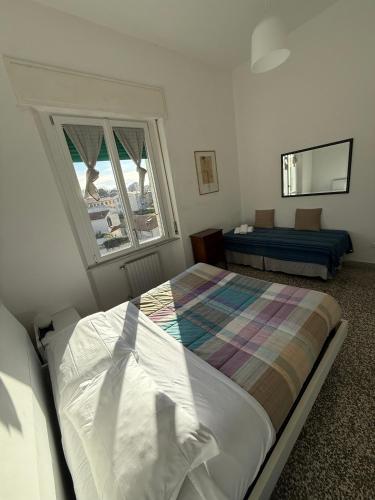 a bedroom with a bed and a window at Il Pesce di Legno in Livorno
