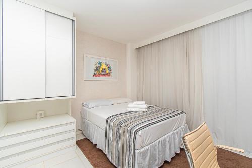 a white bedroom with a bed and a window at Vision Hotel em Brasília 59854 in Brasilia