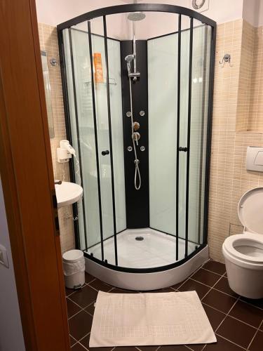 a bathroom with a shower and a toilet at Hotel Vandia in Timişoara