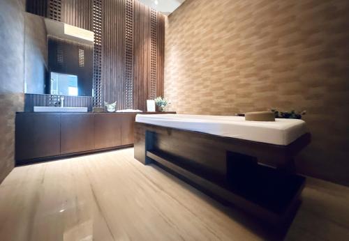 a bathroom with a large tub and a sink at Stylish 2BR Apartment ARC100 Surabaya City Centre with Balcony by Le Ciel Hospitality in Surabaya