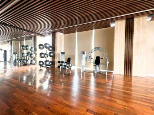 a gym with a hardwood floor and a gymngth at Stylish 2BR Apartment ARC100 Surabaya City Centre with Balcony by Le Ciel Hospitality in Surabaya