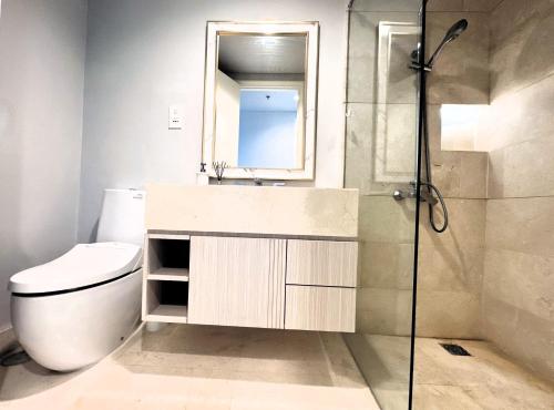 a bathroom with a toilet and a sink and a shower at Stylish 2BR Apartment ARC100 Surabaya City Centre with Balcony by Le Ciel Hospitality in Surabaya