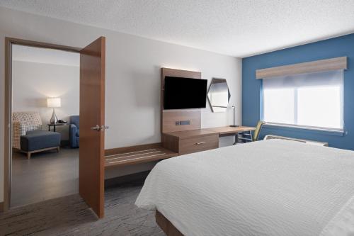 a hotel room with a bed and a flat screen tv at Holiday Inn Express Sheboygan-Kohler / I-43 by IHG in Sheboygan