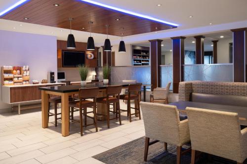 a dining room and kitchen with a table and chairs at Holiday Inn Express Sheboygan-Kohler / I-43 by IHG in Sheboygan